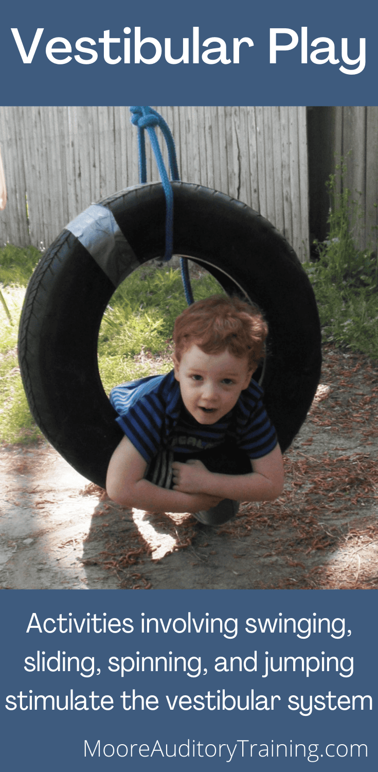 Vestibular Play young boy on a tire swing
