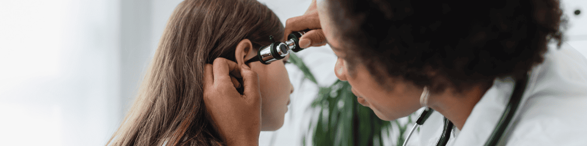 Ear Infection banner photo doctor checking girl's ear for an ear infection