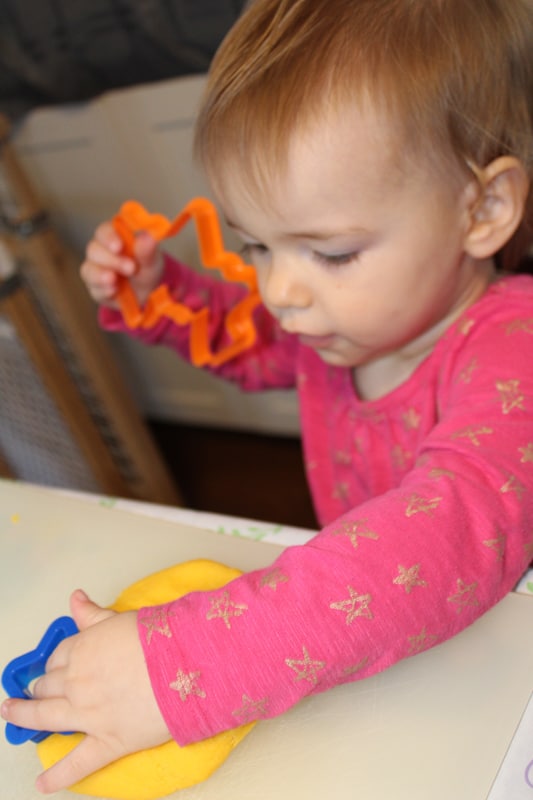 young girl playing with playdoh