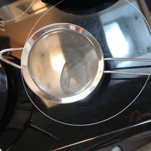 fine mesh strainer sitting on a stove top