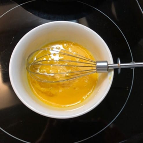 eggs, vanilla, and salt mixed up in a bowl