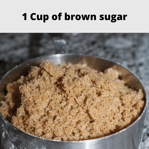 1 cup of brown sugar in a stainless steal 1 cup measuring cup sitting on the counter.