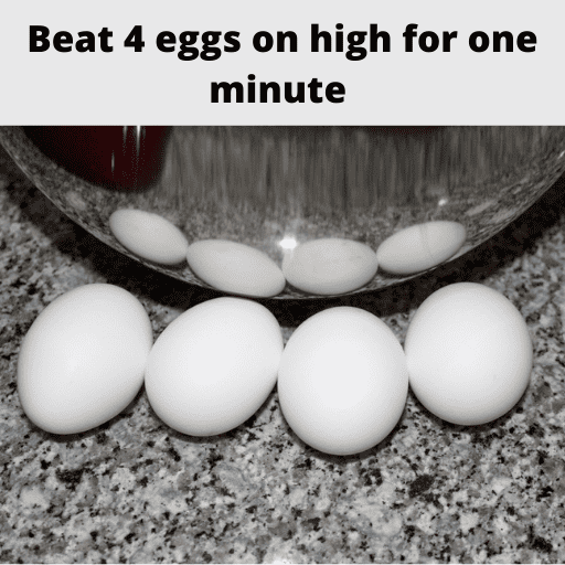 four eggs sitting on the counter in front of a stainless steal mixing bowl. 