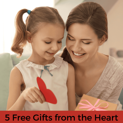 mother and young daughter wrapping a gift. The daughter is holding a red paper heart