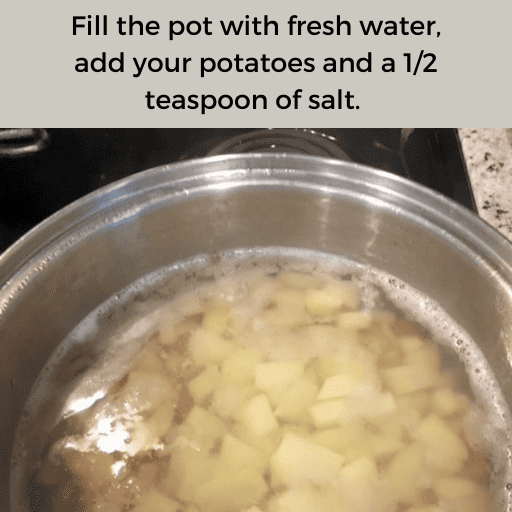 Chopped potatoes in a stainless steel pot on a stovetop. The potatoes are submerged in water and salt has been added to the pot. There is a gray box with black text at the top. 