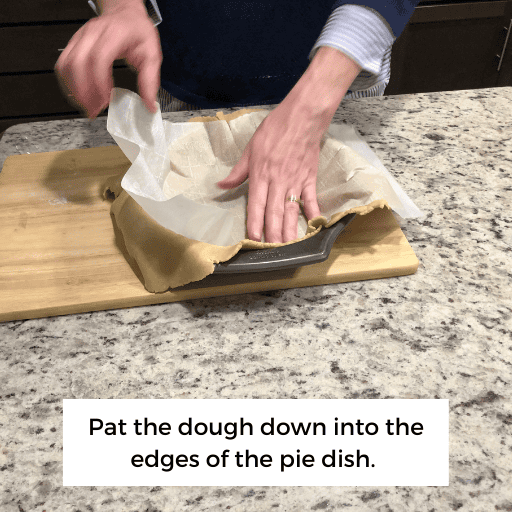 patting the gluten and dairy free pie crust into the pie pan. 