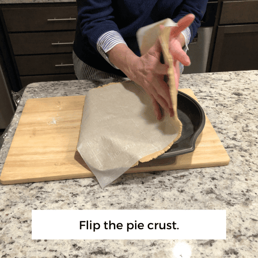 laying the gluten and dairy free pie crust across the pie dish. 