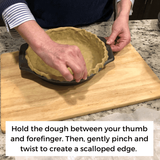 using thumb and forefinger to pinch and twist the edge of the pie crust to make a scalloped edge.