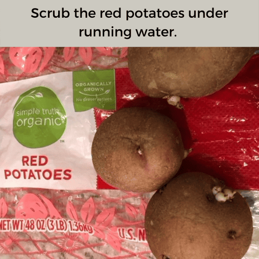 Three small red potatoes sitting on top of a bag of simple truth organic red potatoes. There is a gray box with black text at the top. 