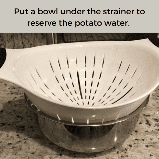 White plastic strainer sitting in a metal mixing bowl on the counter top. There is a gray box with black text at the top.
