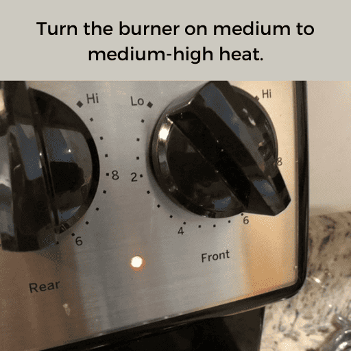 stovetop temperature guage turned to #6. The back plate is gray and the knob is black. There is a gray box with black text at the top.
