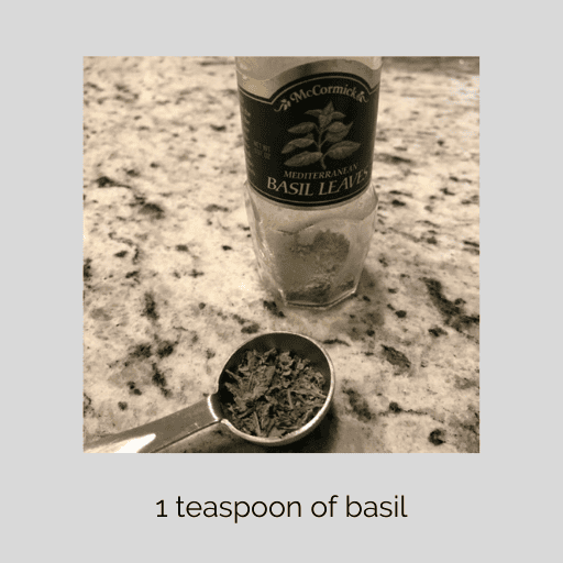 1 teaspoon of basil on the counter in front of the seasoning jar