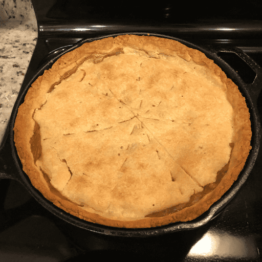 baked gluten and dairy free chicken pot pie in a cast iron skillet sitting on the stovetop