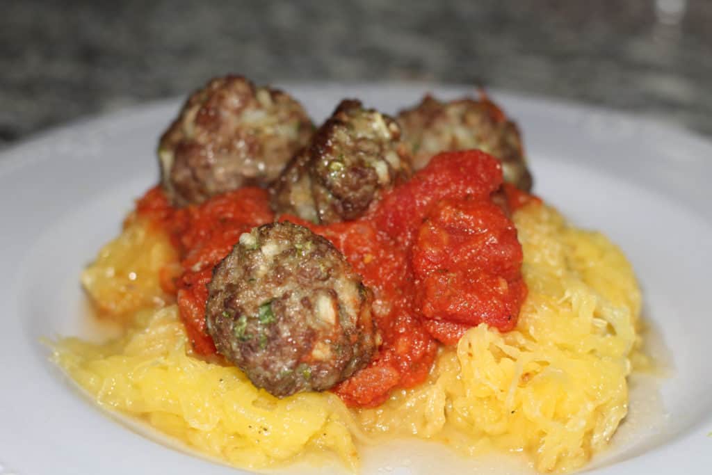 Gluten and dairy free meatballs served on spaghetti squash with pasta sauce.