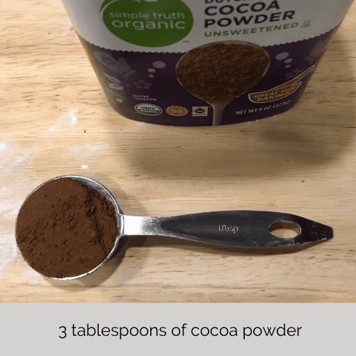 a tablespoon of cocoa powder in front of the container