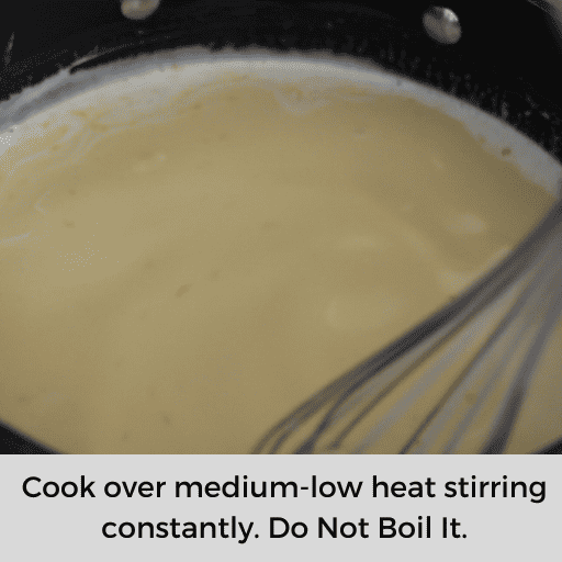 stirring the gluten and dairy free banana pudding on the stovetop with a whisk while it is cooking
