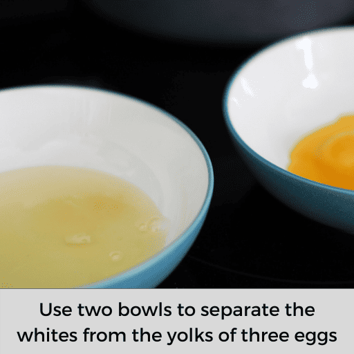 to bowls on a black surface. The one on the left has egg whites and the one of the right has egg yolks.