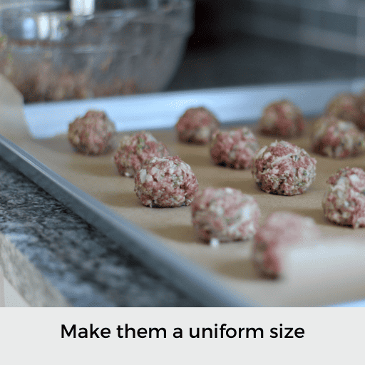 Raw gluten and dairy free meatballs rolled out on a baking sheet