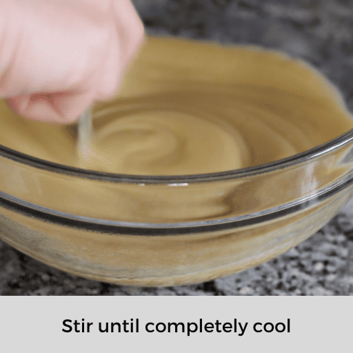stirring the strained pudding in a glass bowl with a spoon