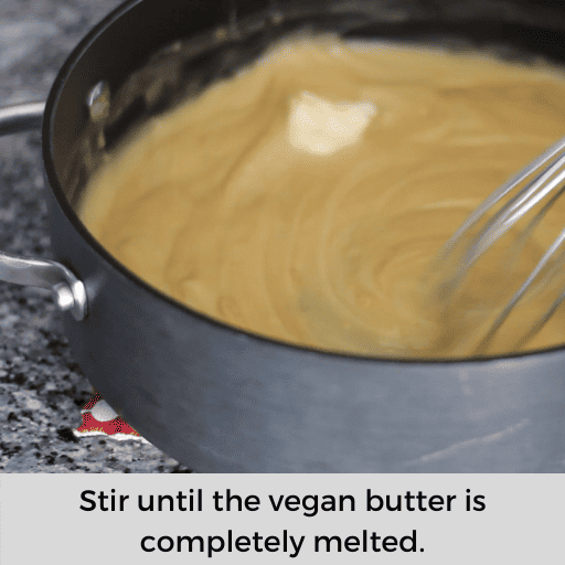 Stirring vegan butter and vanilla extract into the dairy and gluten free banana pudding. 