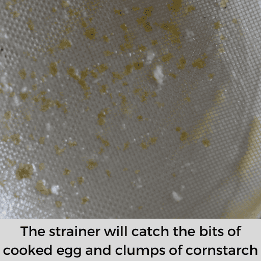 strainer with bits of cooked eggs and clumps of cornstarch.