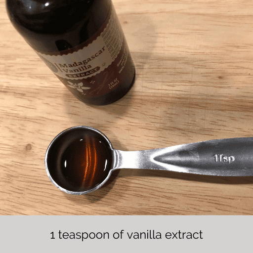 i teaspoon of vanilla extract sitting on a cutting board in front of the bottle