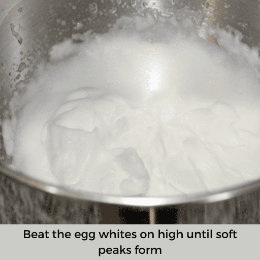 stiff egg whites in a stainless steal mixing bowl