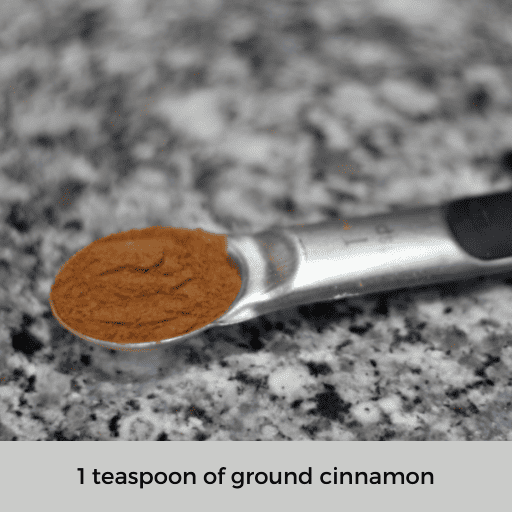 1 teaspoon measuring spoon filled with ground cinnamon sitting on the countertop