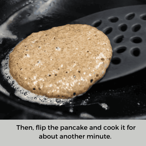 spatula lifting a gluten and dairy free pancake to flip it over in a cast iron skillet