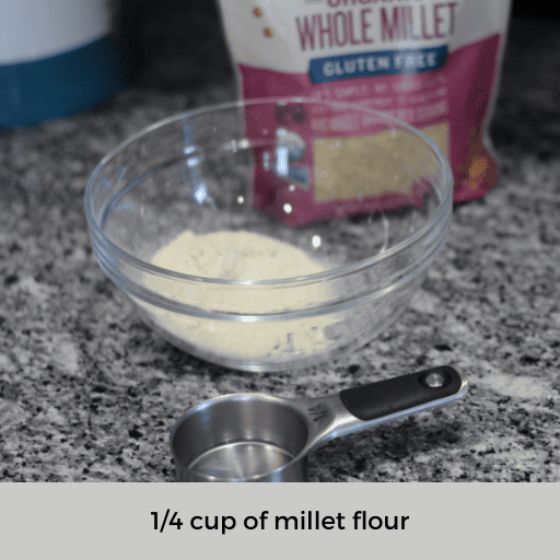 1/4 cup measuring cup sitting in front of a glass bowl of millet flour and a bag of whole millet grains. 
