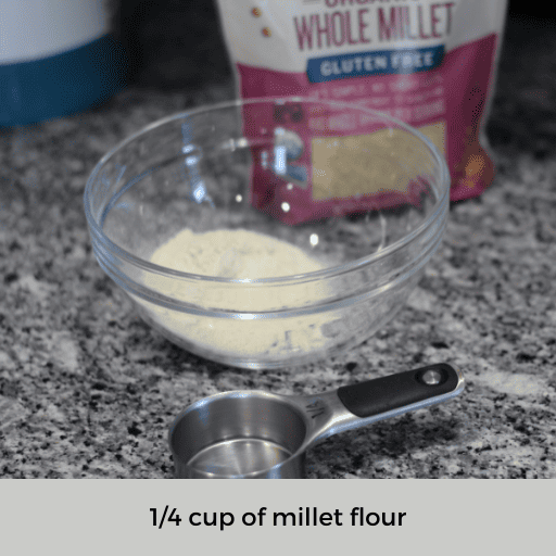 1/4 cup measuring cup sitting in front of a glass bowl of millet flour and a bag of whole millet grains.