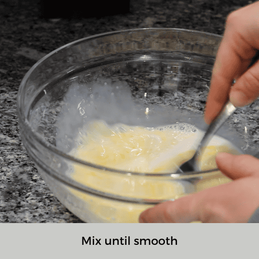 mixing liquid ingredients for gluten and dairy free pancakes in a glass mixing bowl with a fork