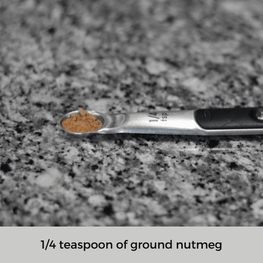 one fourth teaspoon filled with nutmeg sitting on the countertop