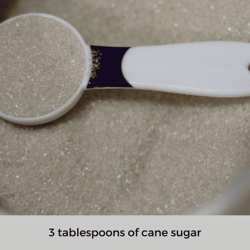 a tablespoon of sugar sitting on top of a mound of sugar.