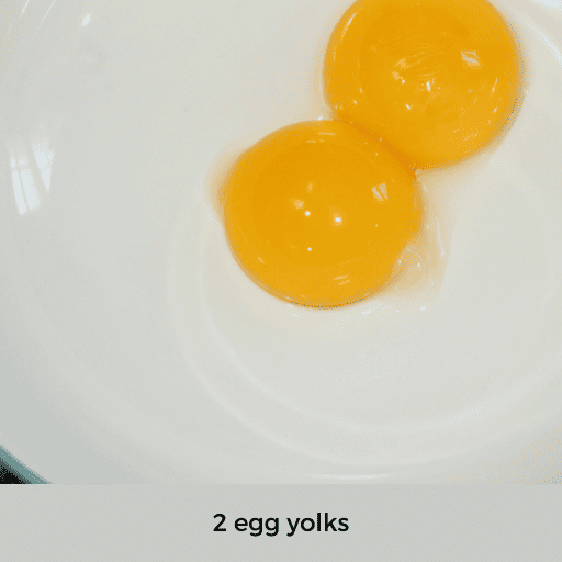 two yellow egg yolks in a bowl.