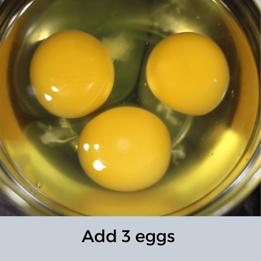 three eggs in a glass bowl