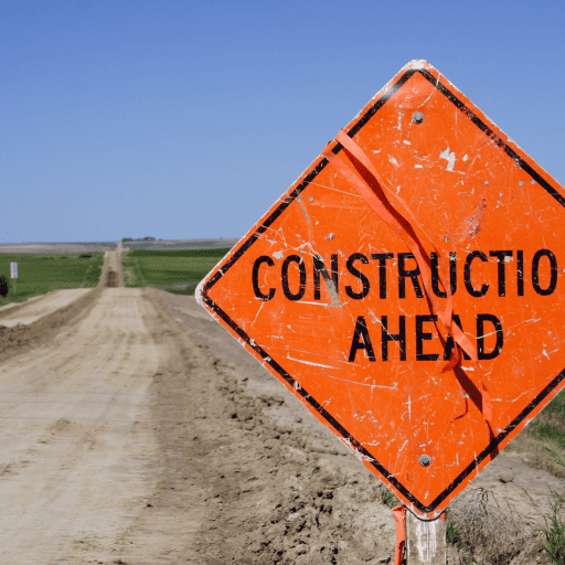 road construction sign along the side of a gravel road to indication what the ear brain connection is like when there is CAPD without hearing aids. 