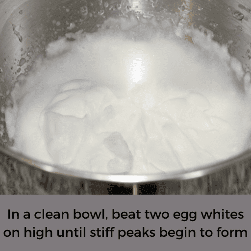 beaten egg whites in a stainless steel mixing bowl. 