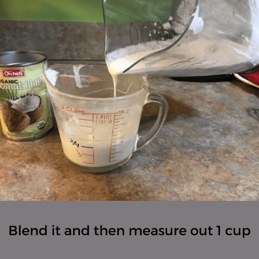 pour canned coconut milk from a blender into a measuring cup