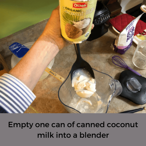 emptying canned coconut milk into a blender