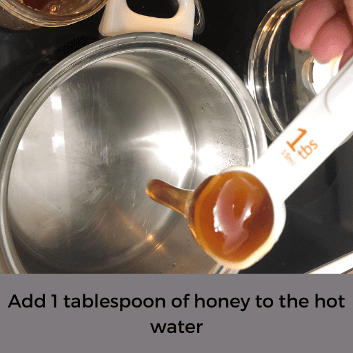 honey going into a pot of hot water 