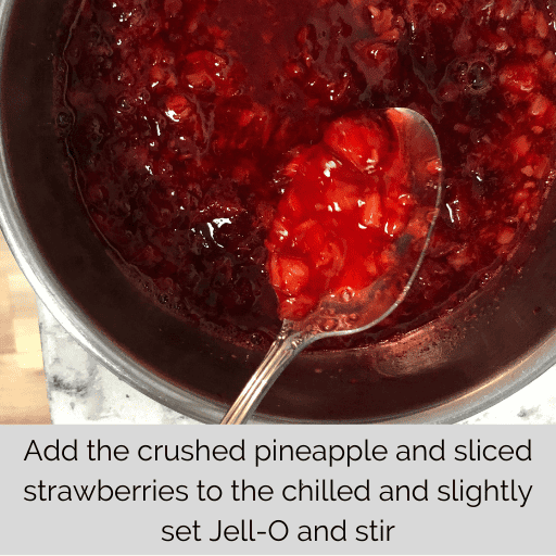 strawberries and pineapple mixed into the strawberry jell-o