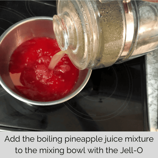 boiling pineapple juice being pour out of the glass kettle into the metal bowl with the strawberry jell-o powder in it