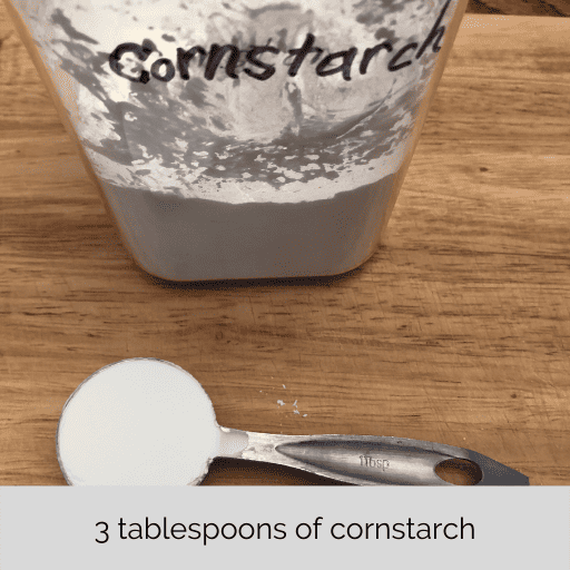 one tablespoon of cornstarch with the container behind it