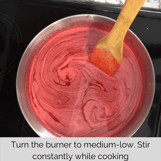 wooden spatula stirring the gel for the gluten and dairy free strawberry pie