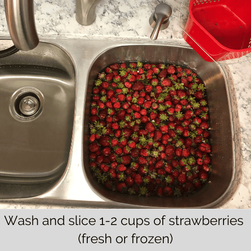 a sink full of strawberries soaking