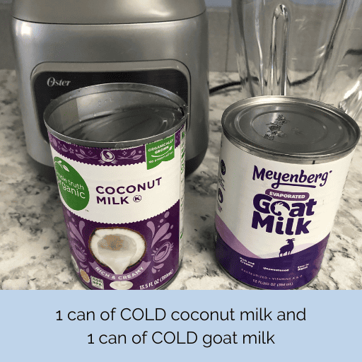 canned coconut and goat milk sitting on the counter in front of the blender