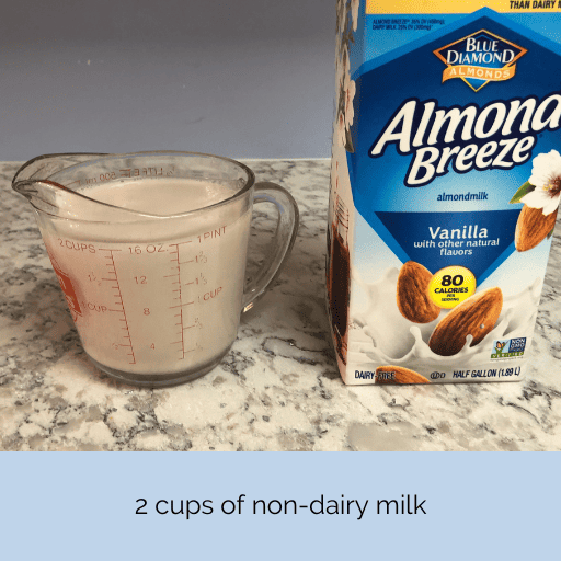 two cups of vanilla almond breeze milk in a glass measuring cup 