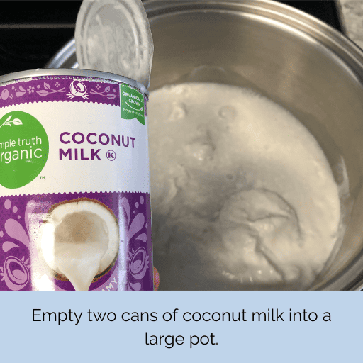 can of coconut milk held above a pot with the contents of the can in it.