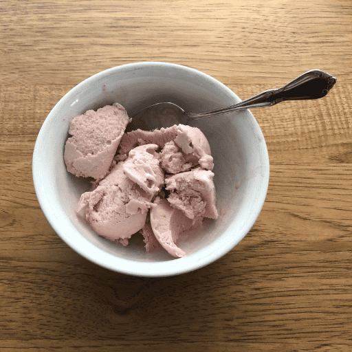 gluten and dairy free ice cream in a white bowl with a spoon